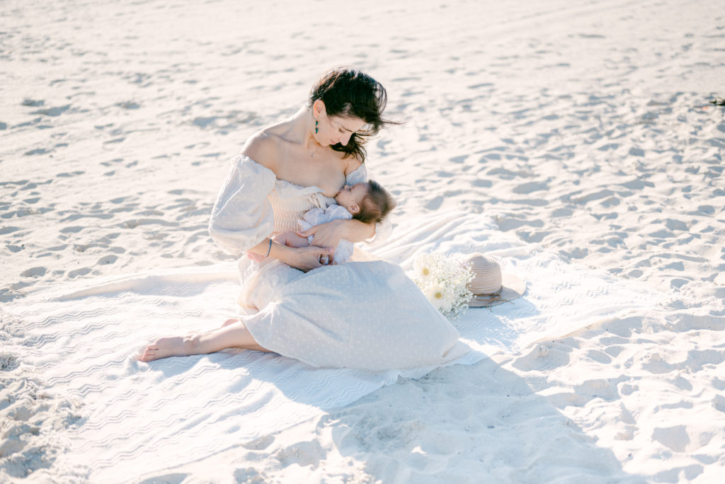 Mom breastfeeding her newborn baby on the beach in Miami, FL