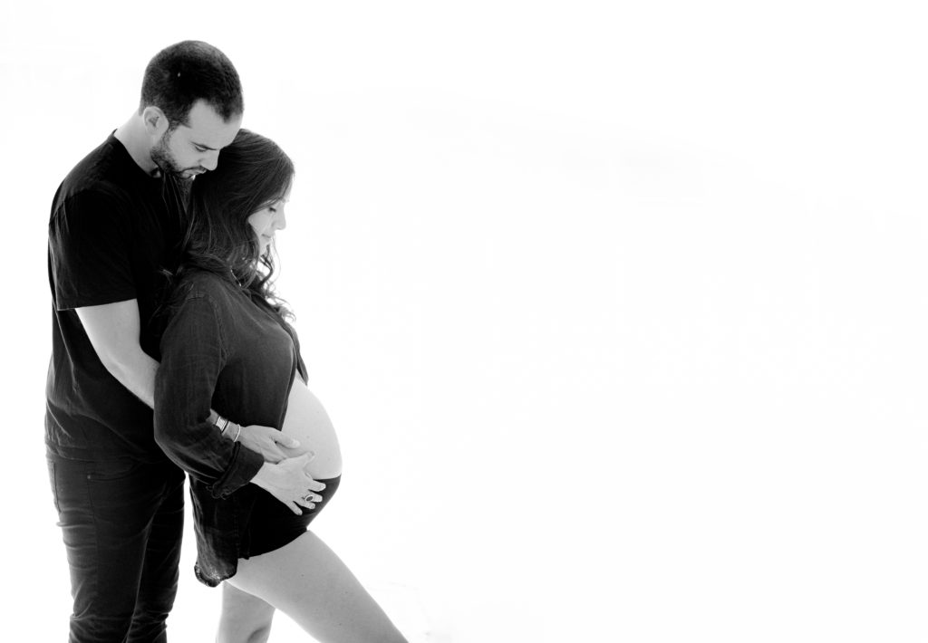 Black and white timeless photo of parents-to-be in Miami Beach. FL