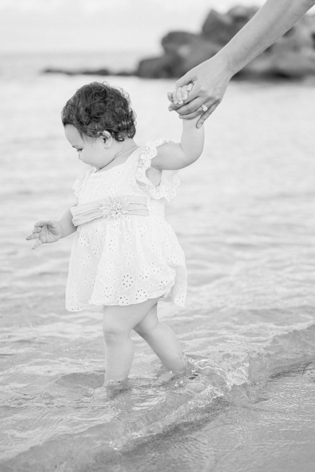 Baby girl walking on the beach