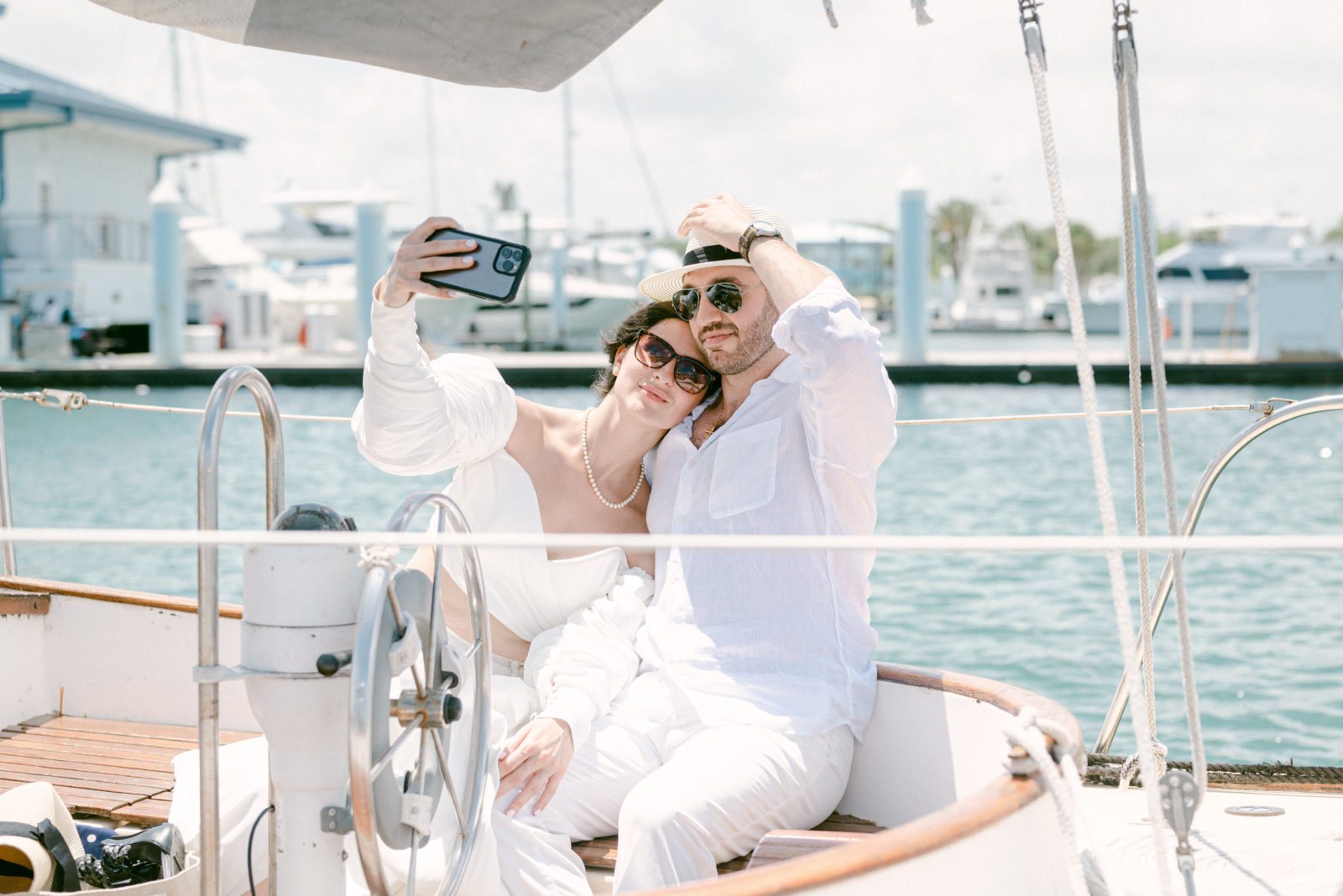 Newly wed couple taking a selfie on a boat