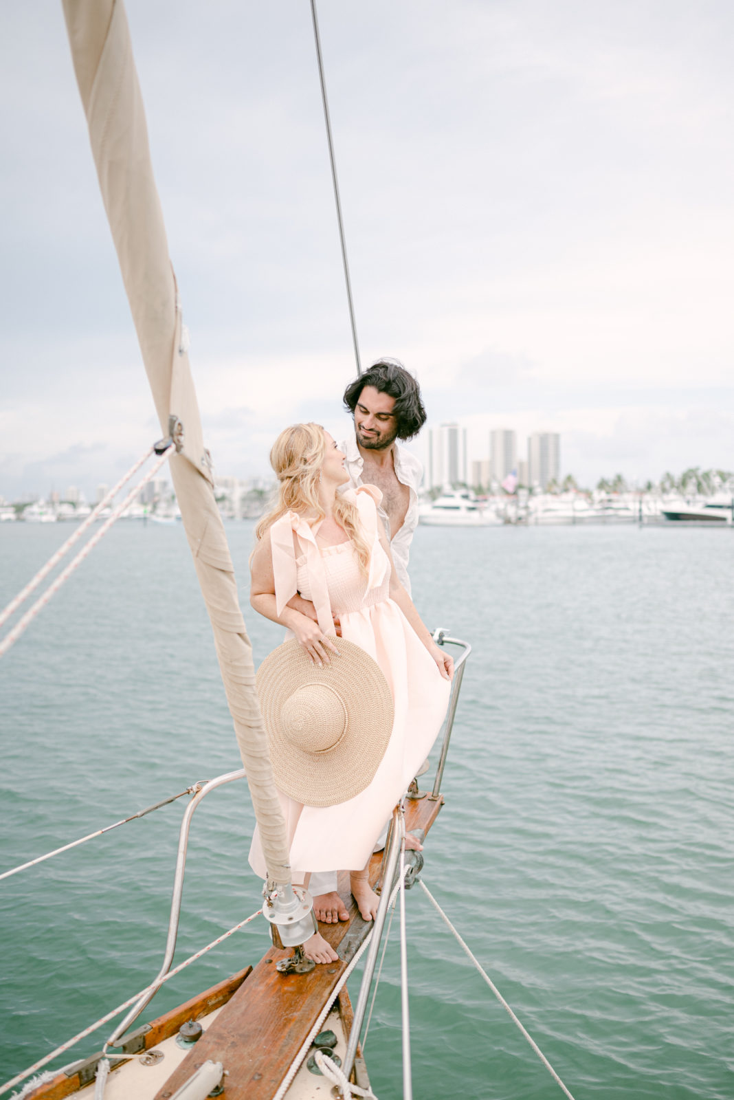 Couple on a sailboat with Miami skyline view 