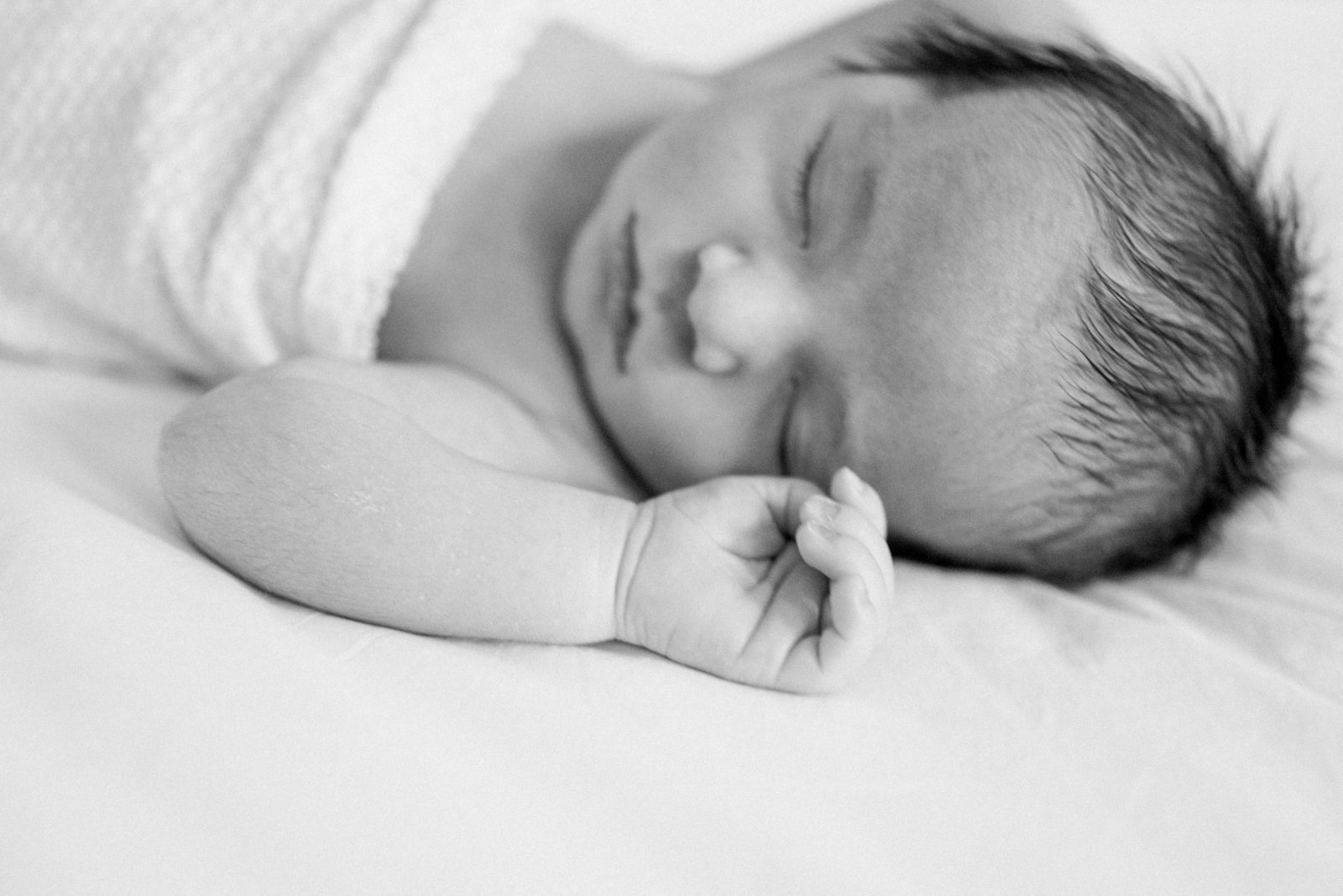 Black and white image of a sleeping newborn