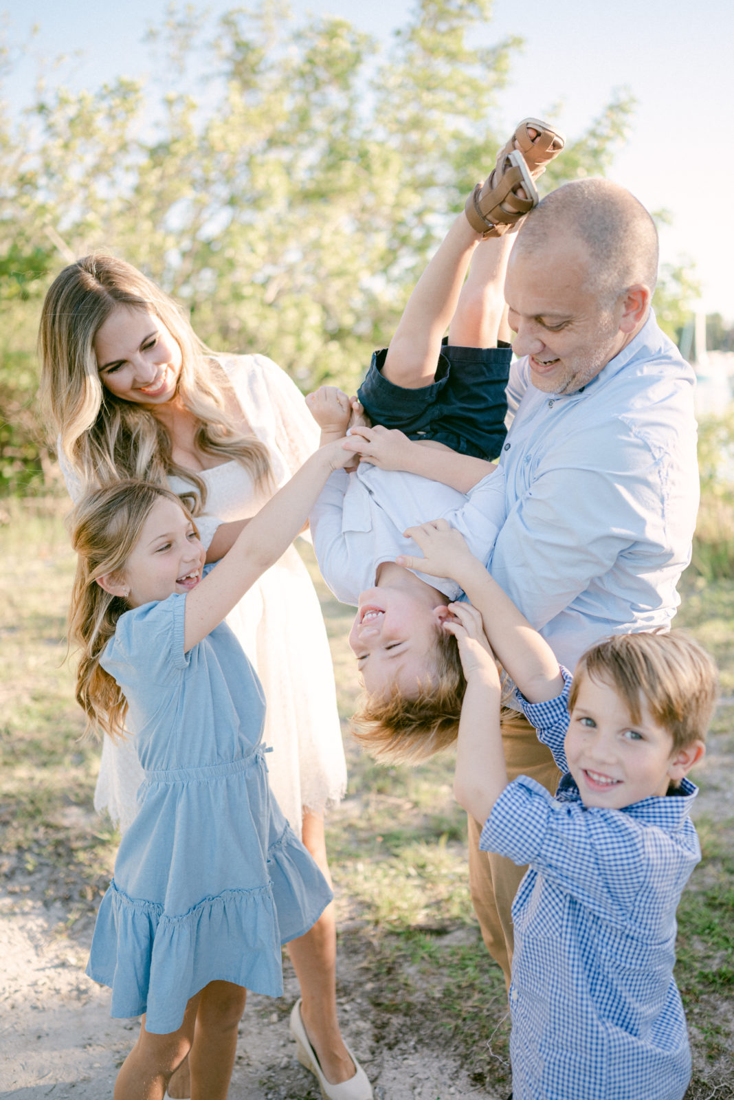 Whole family playing and tickling each other during Fall Mini Sessions in Miami 