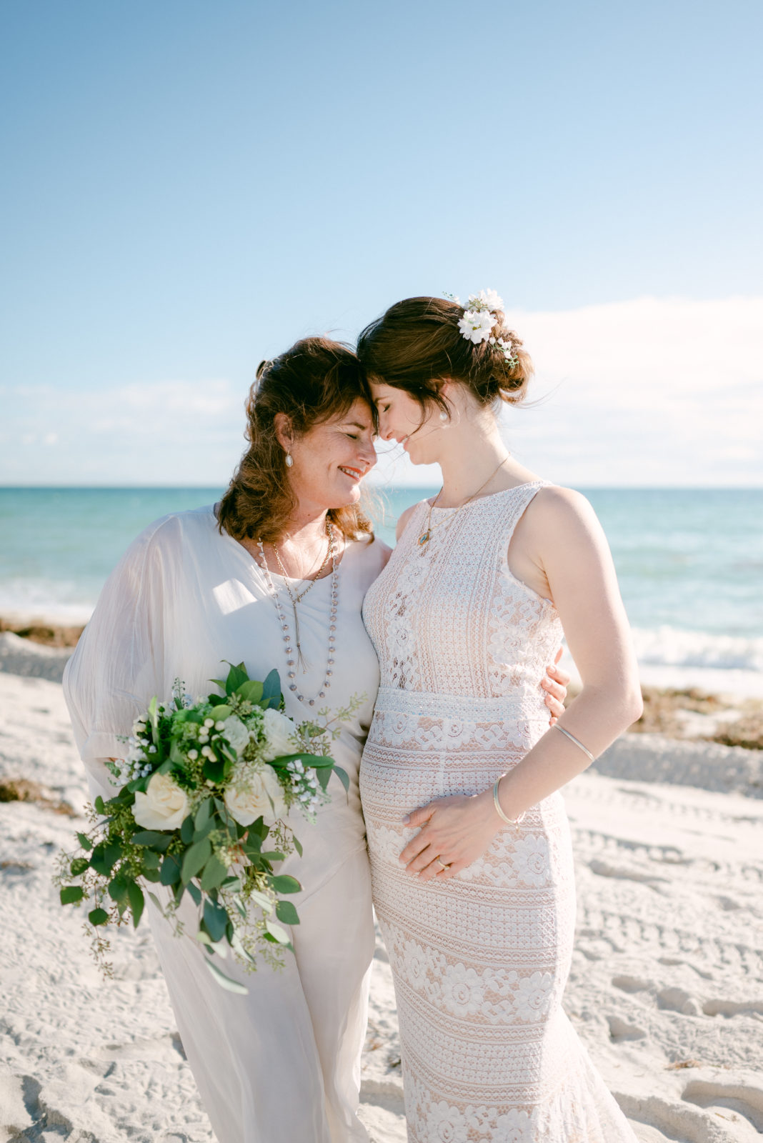 Mom and her bride daughter on the beach