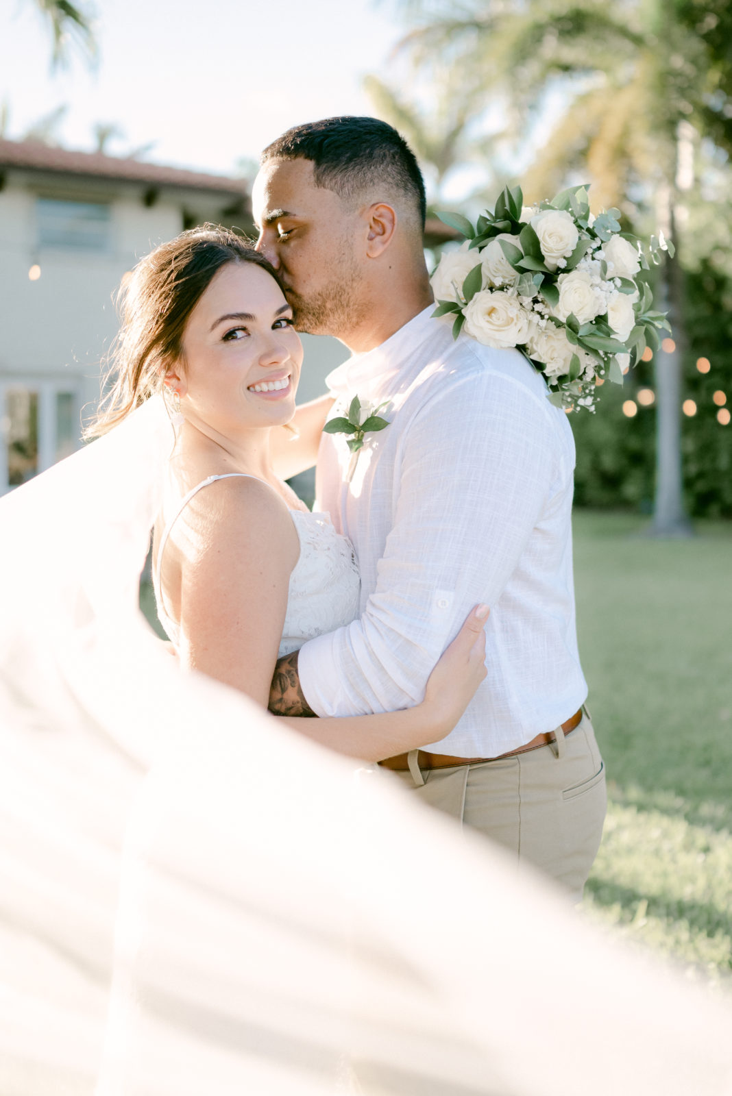 Backyard Elopement in Miami Bride and Groom portrait with leading veil