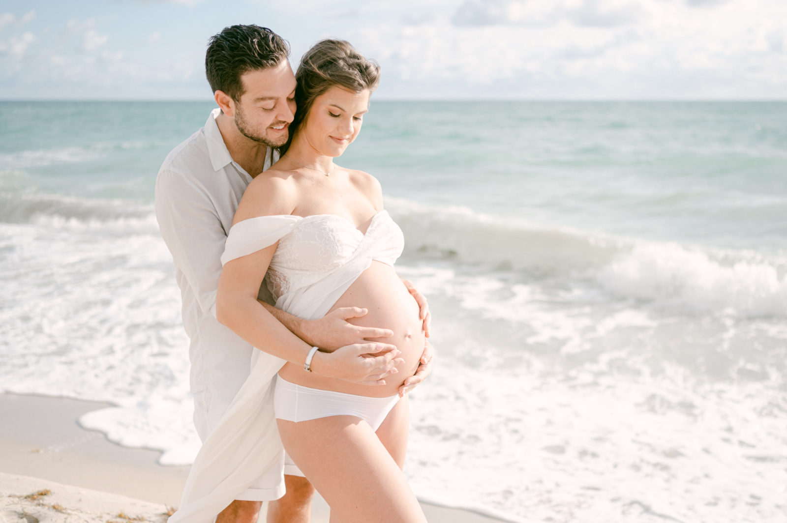 Pregnant couple taking Maternity photos in Bal Harbour Beach