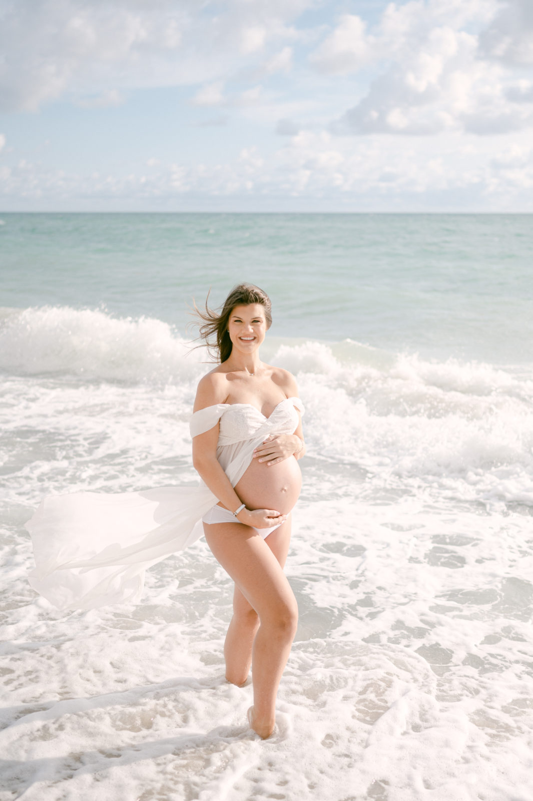 Beautiful blue eyed pregnant mom on the beach