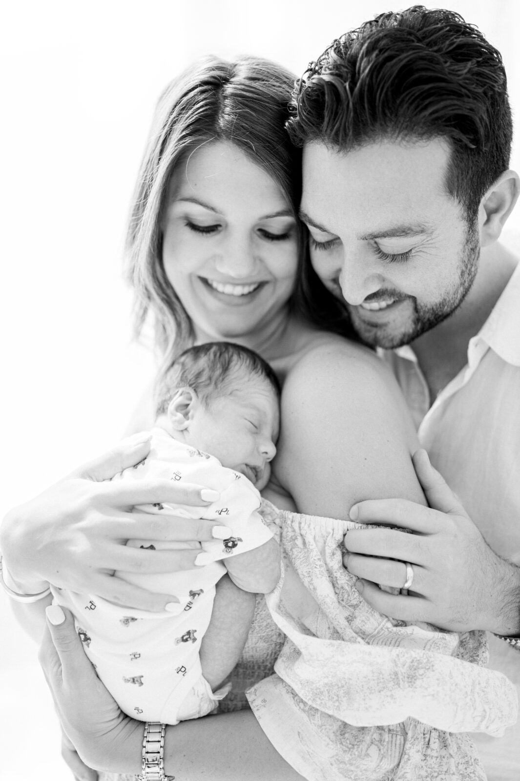 Black and white new family portrait with newborn