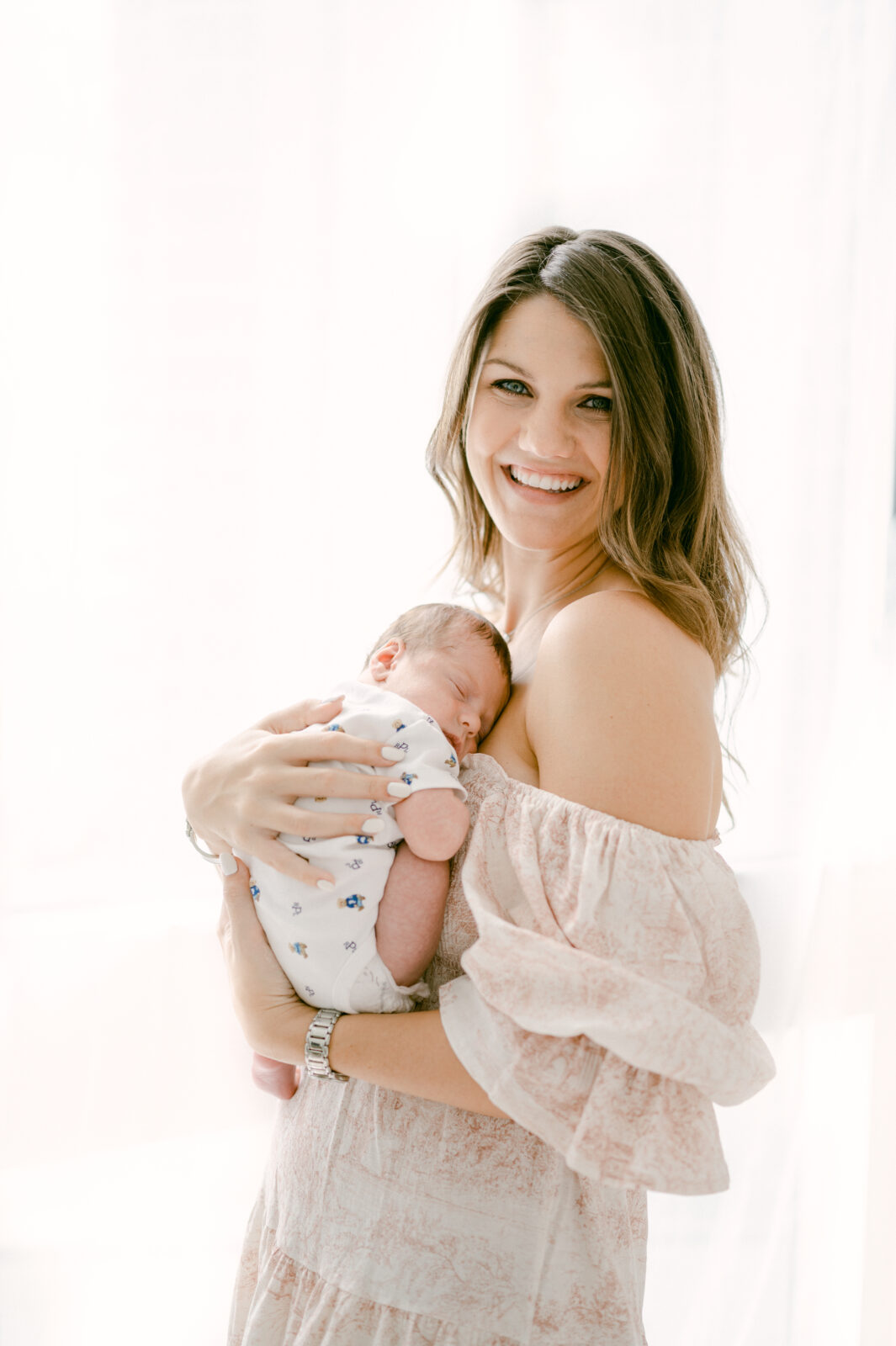 Beautiful blue eyed mom in a pink dress during her Miami newborn session
