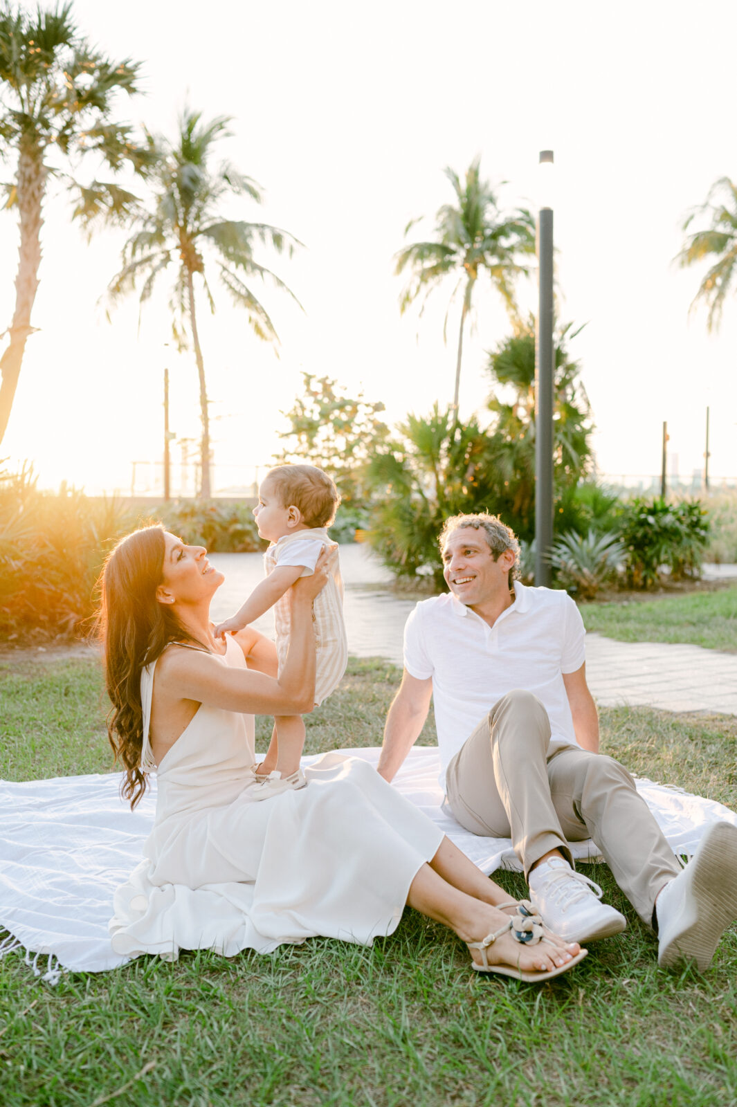 Family playing in a park during golden hour by Miami Children Photographer
