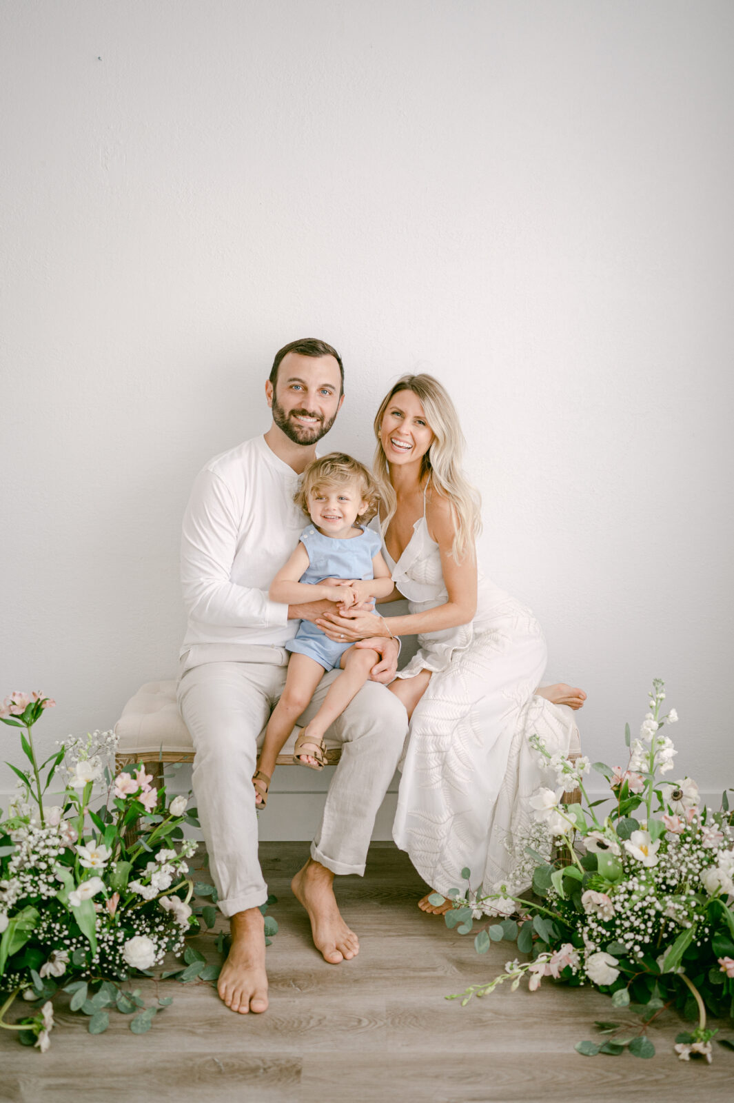 Laughing family photo with flowers during Mother's day mini sessions in Miami