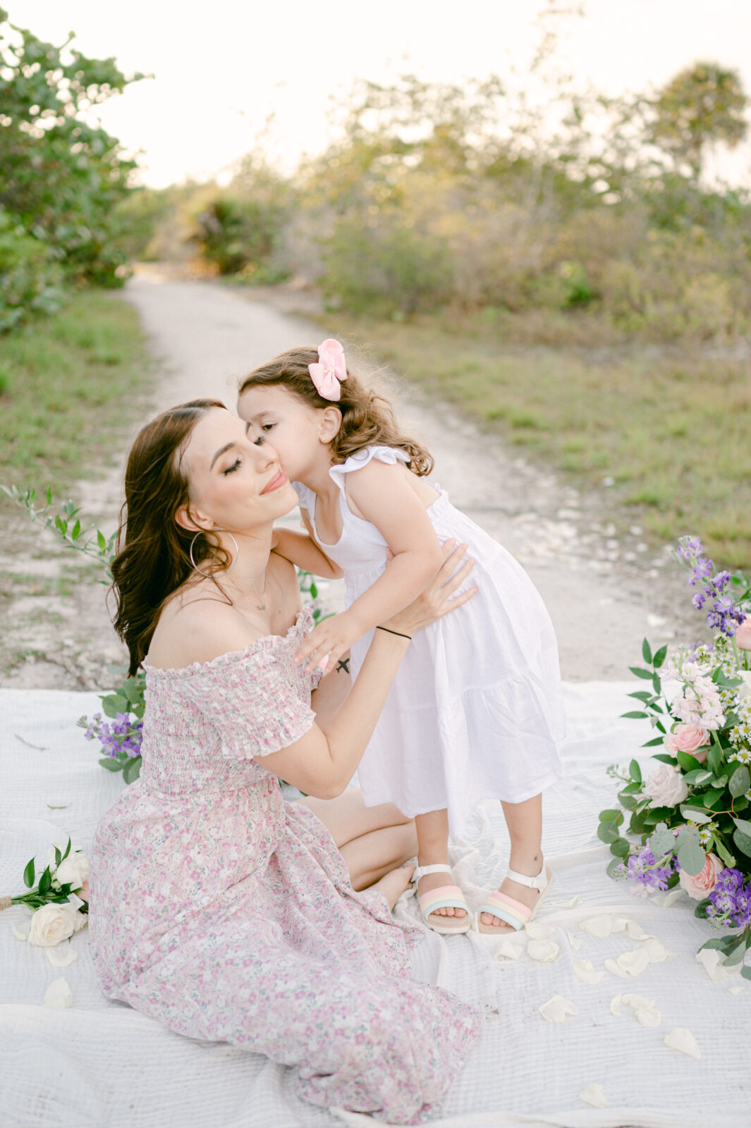 Toddler girl kissing her mom during their Miami photography session