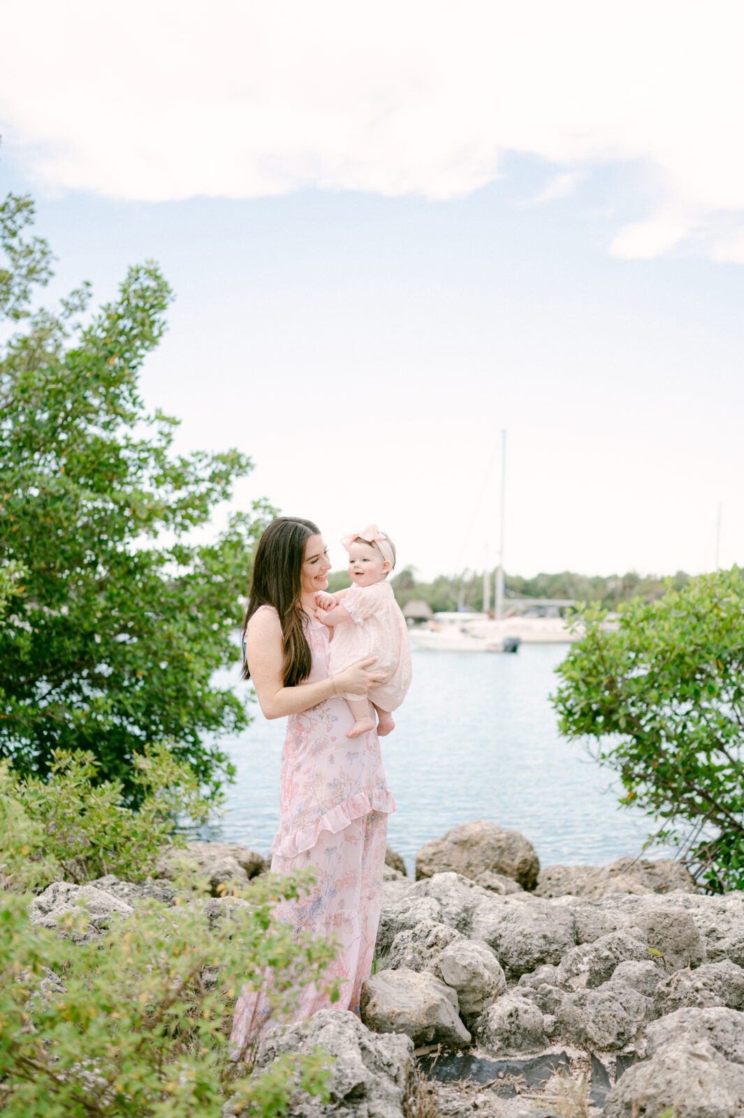 Mom holding her baby with a Key Biscayne boat view