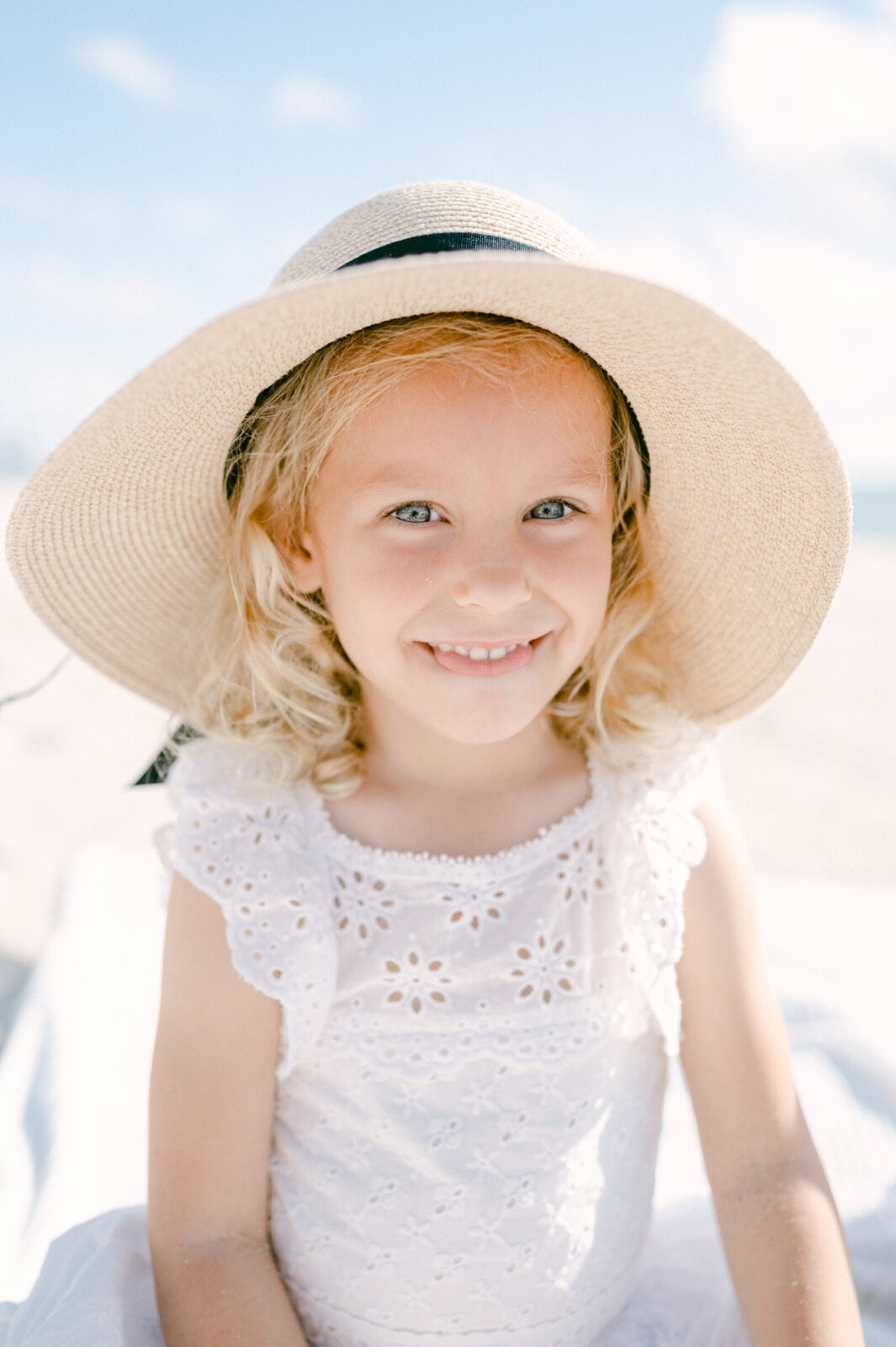 Summer hat blue eyed girl toddler portrait in Miami Beach