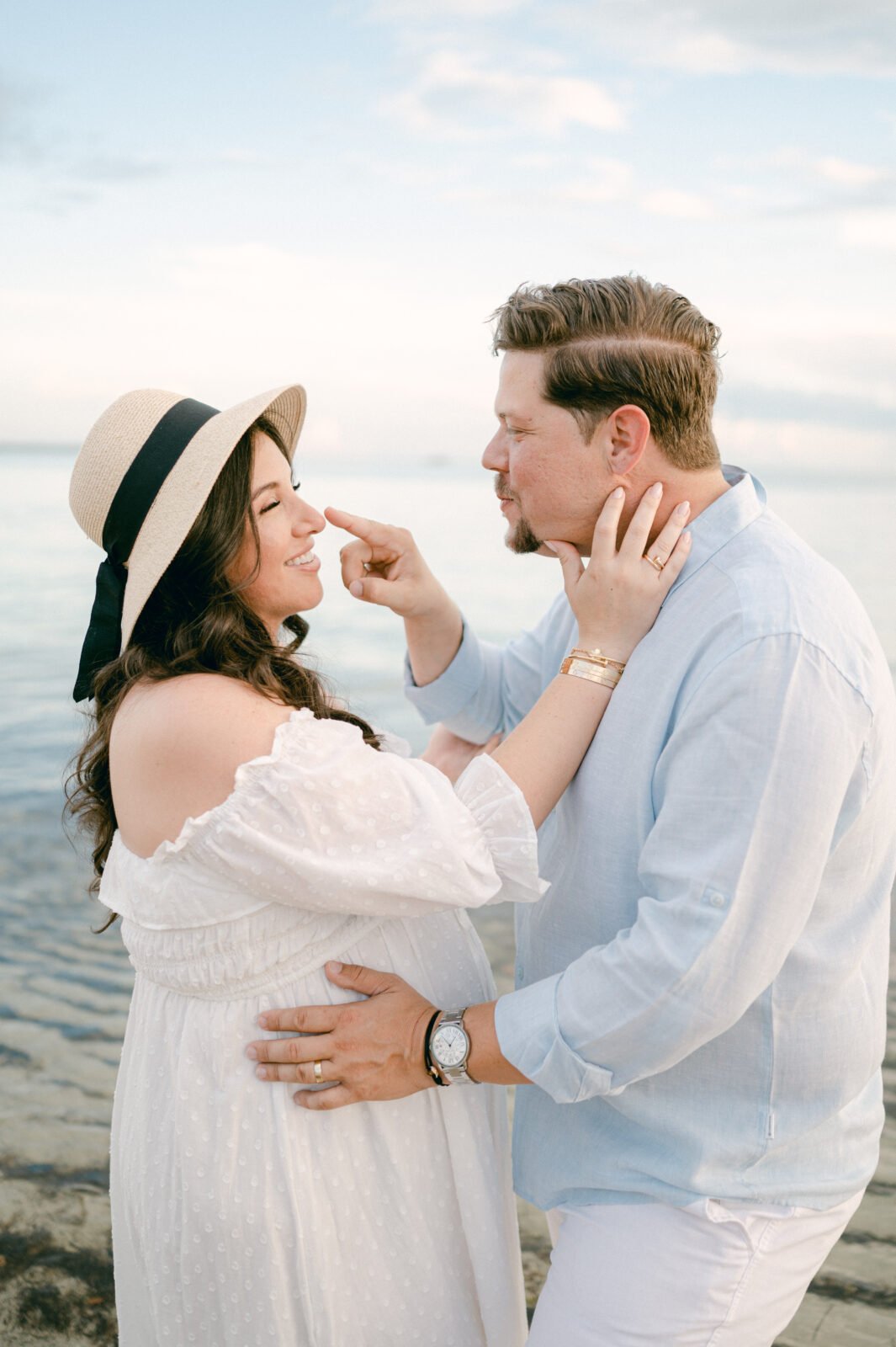 Couple having fun together during their Miami maternity session