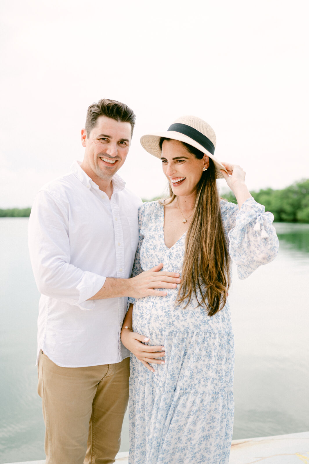 Mom and dad laughing during their Miami maternity photos