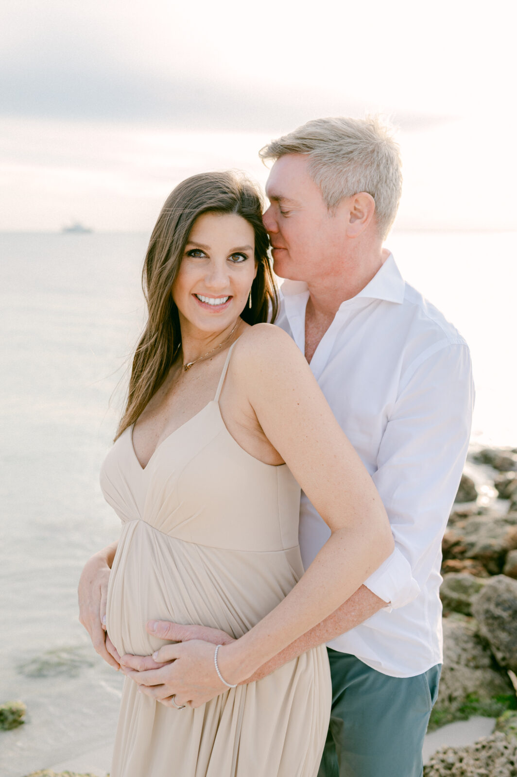 Parents to be on the beach during pregnancy photoshoot