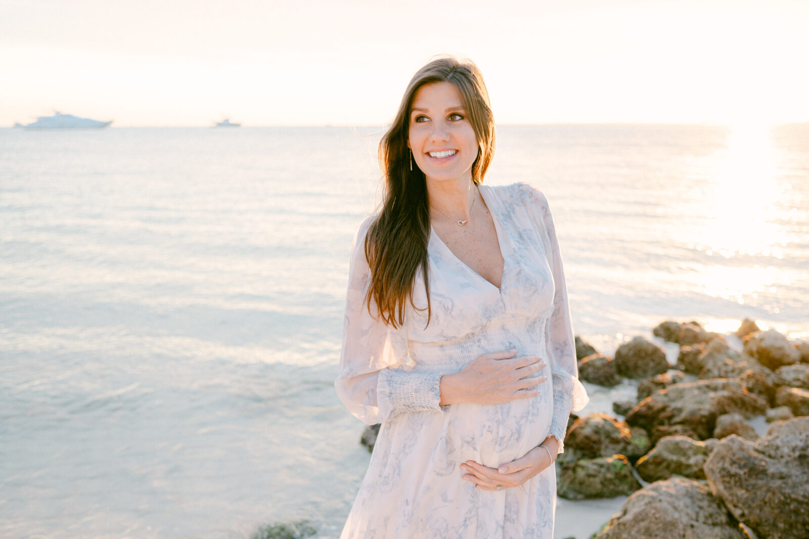 Pregnancy photos on the beach during sunset 