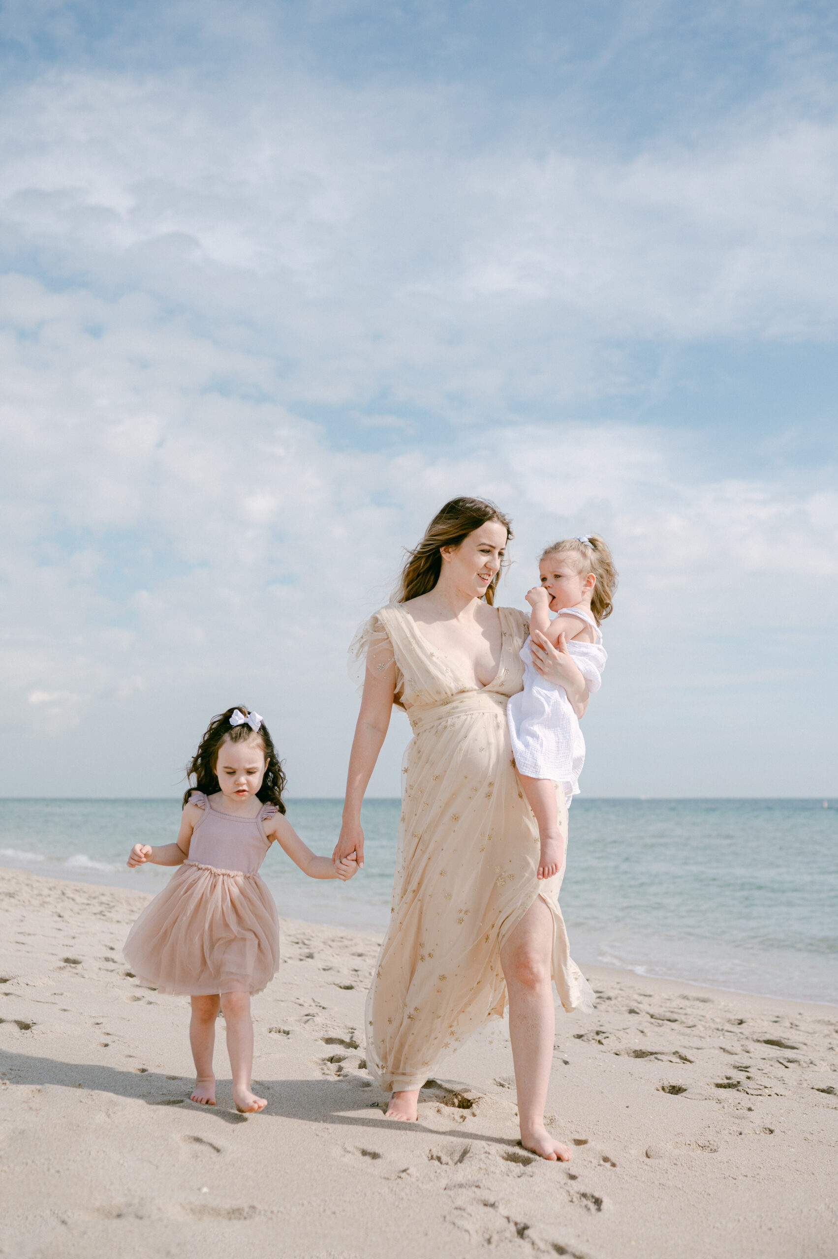 Mon walking on the beach with her two daughters in Miami