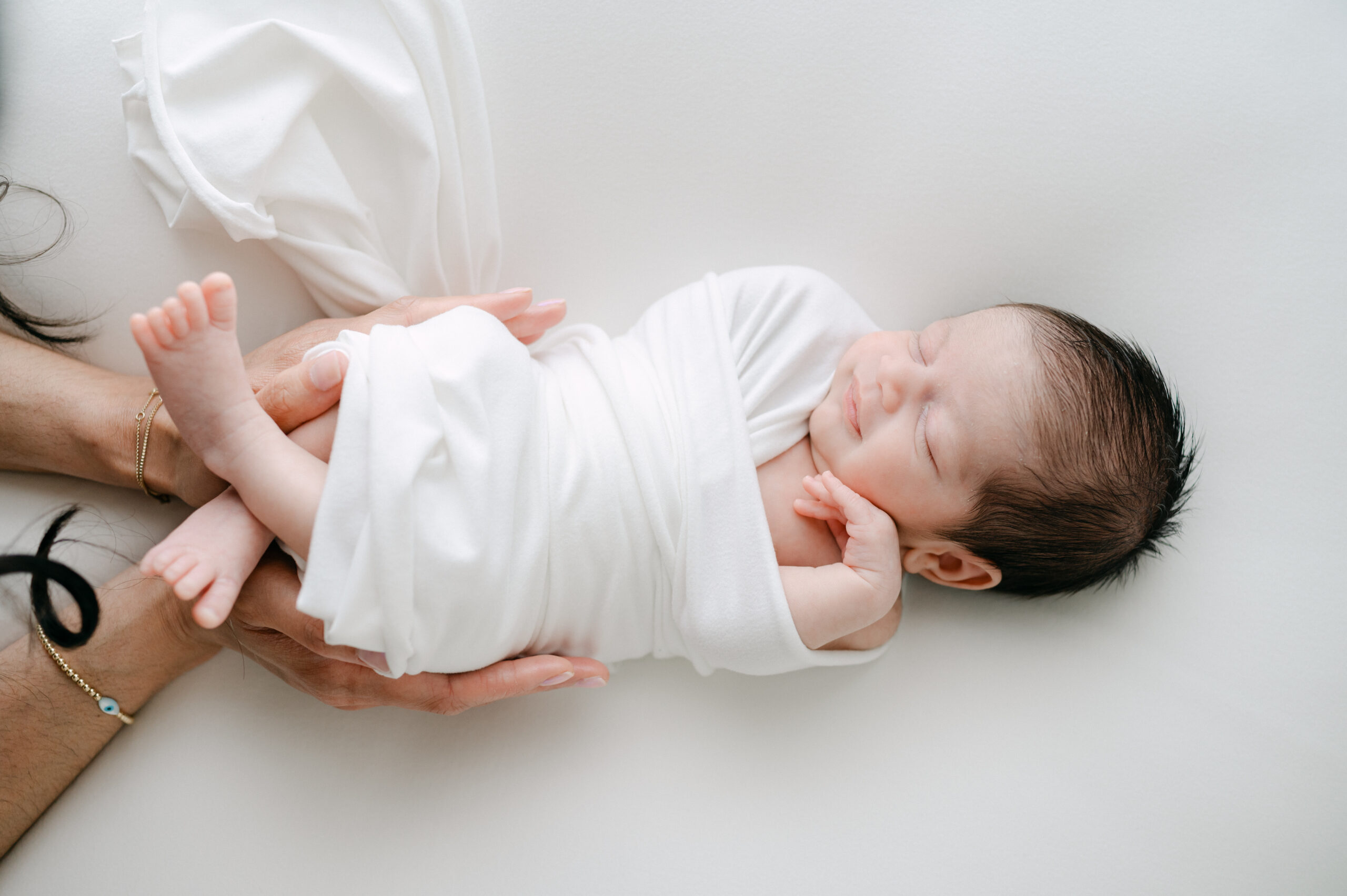 Smiling newborn baby during photoshoot