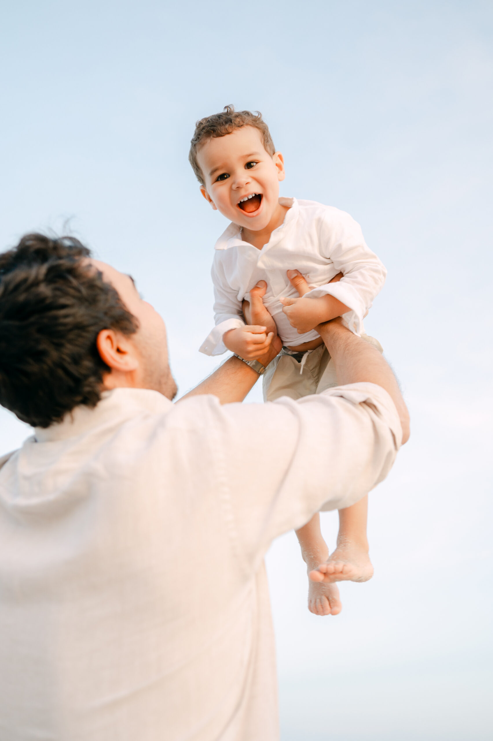 Dad throwing his boy in the air