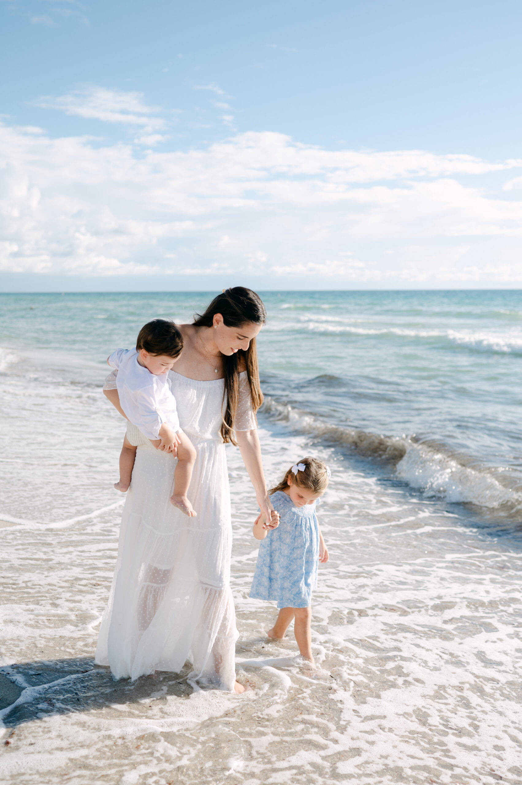 Mom walking in the water with her children