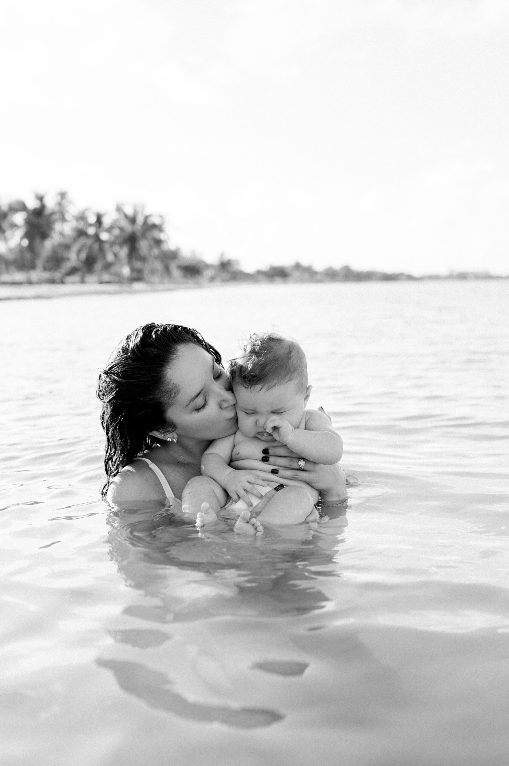 Black and white mommy and baby in the water