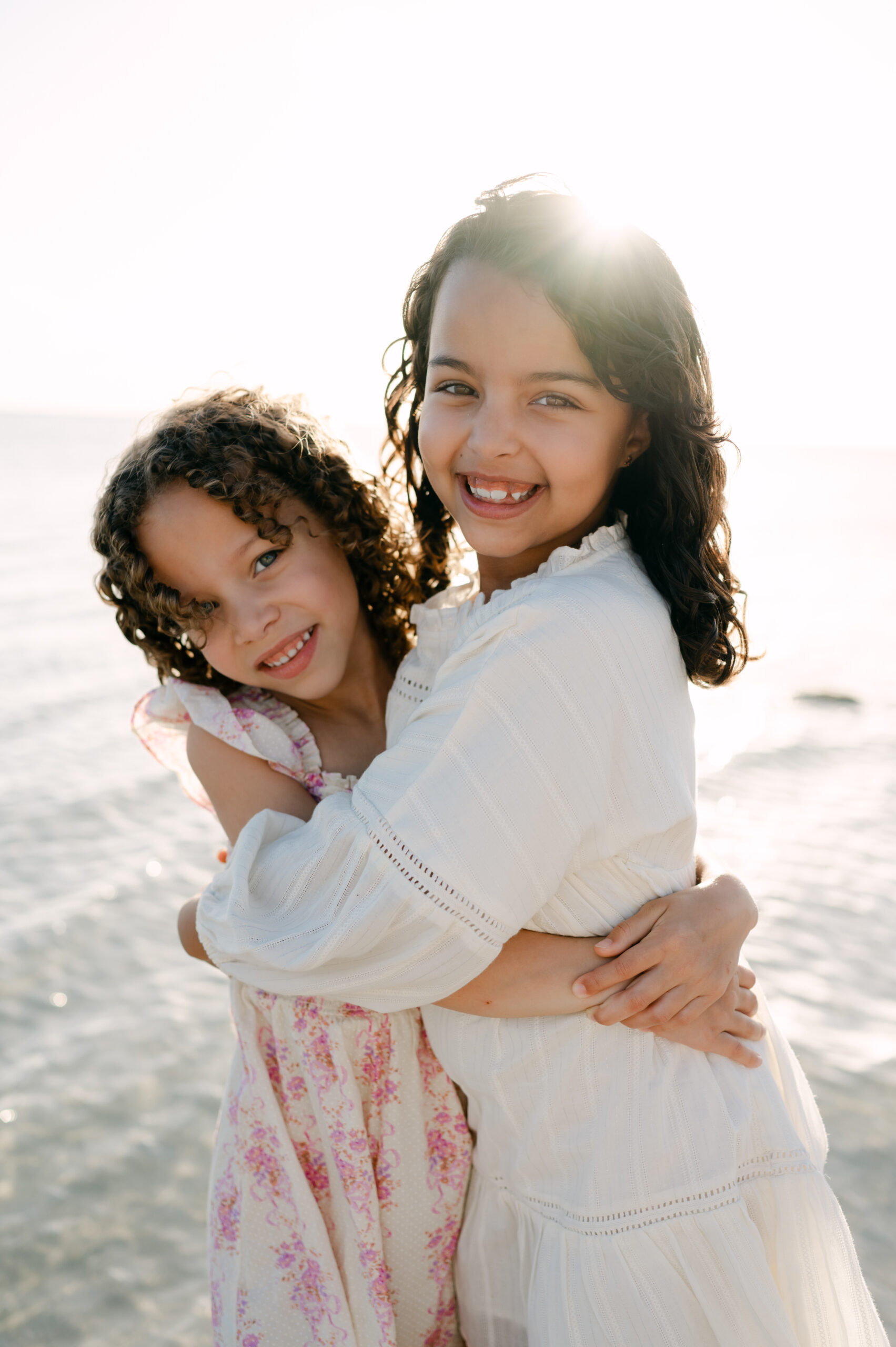 Sisters hugging at the beach during Miami photoshoot