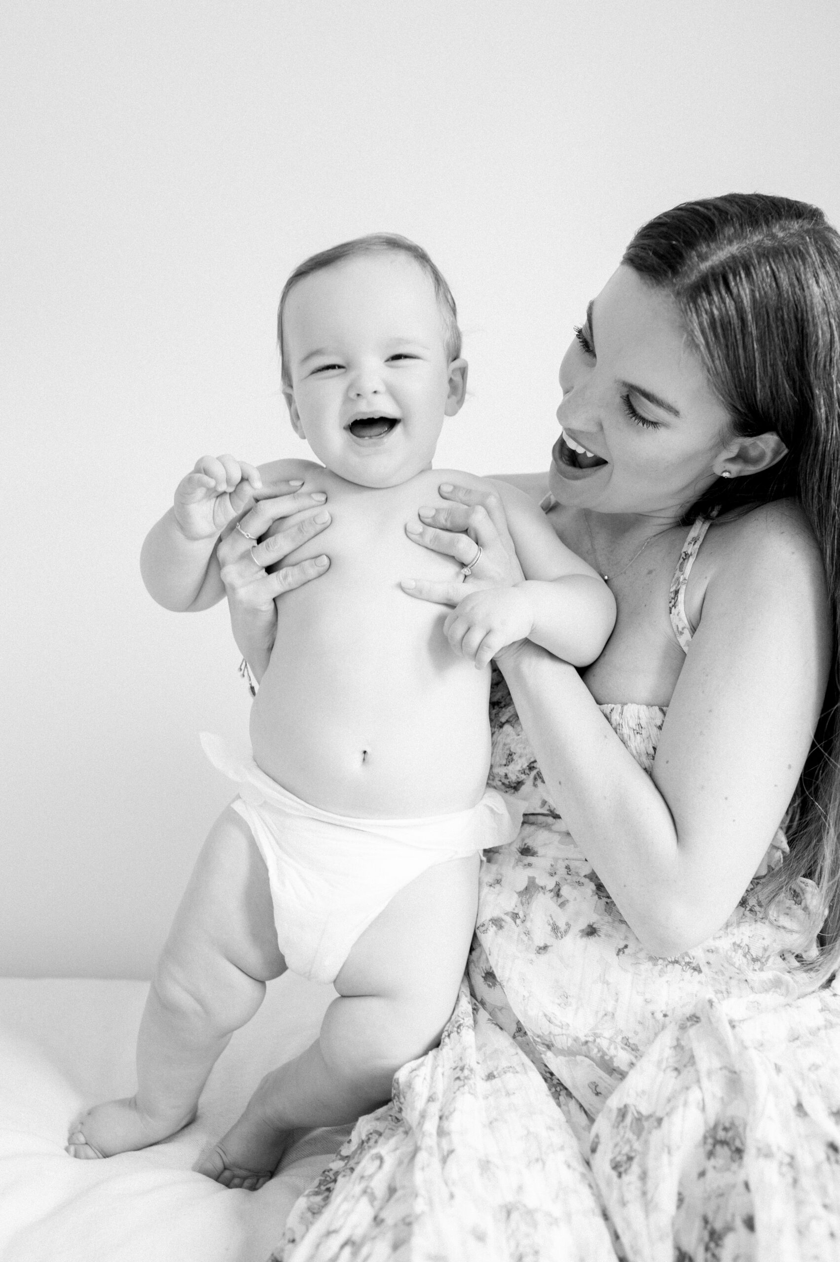 Mom smiling at her 1 year old baby by Miami family photographer