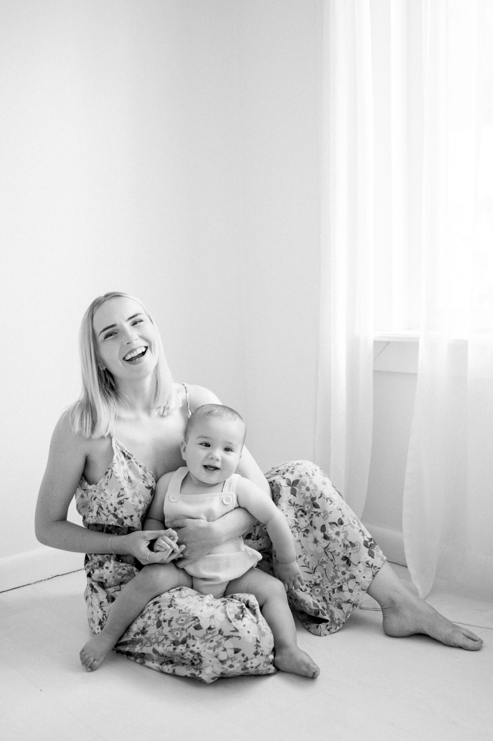 Mom laughing with her baby on her lap