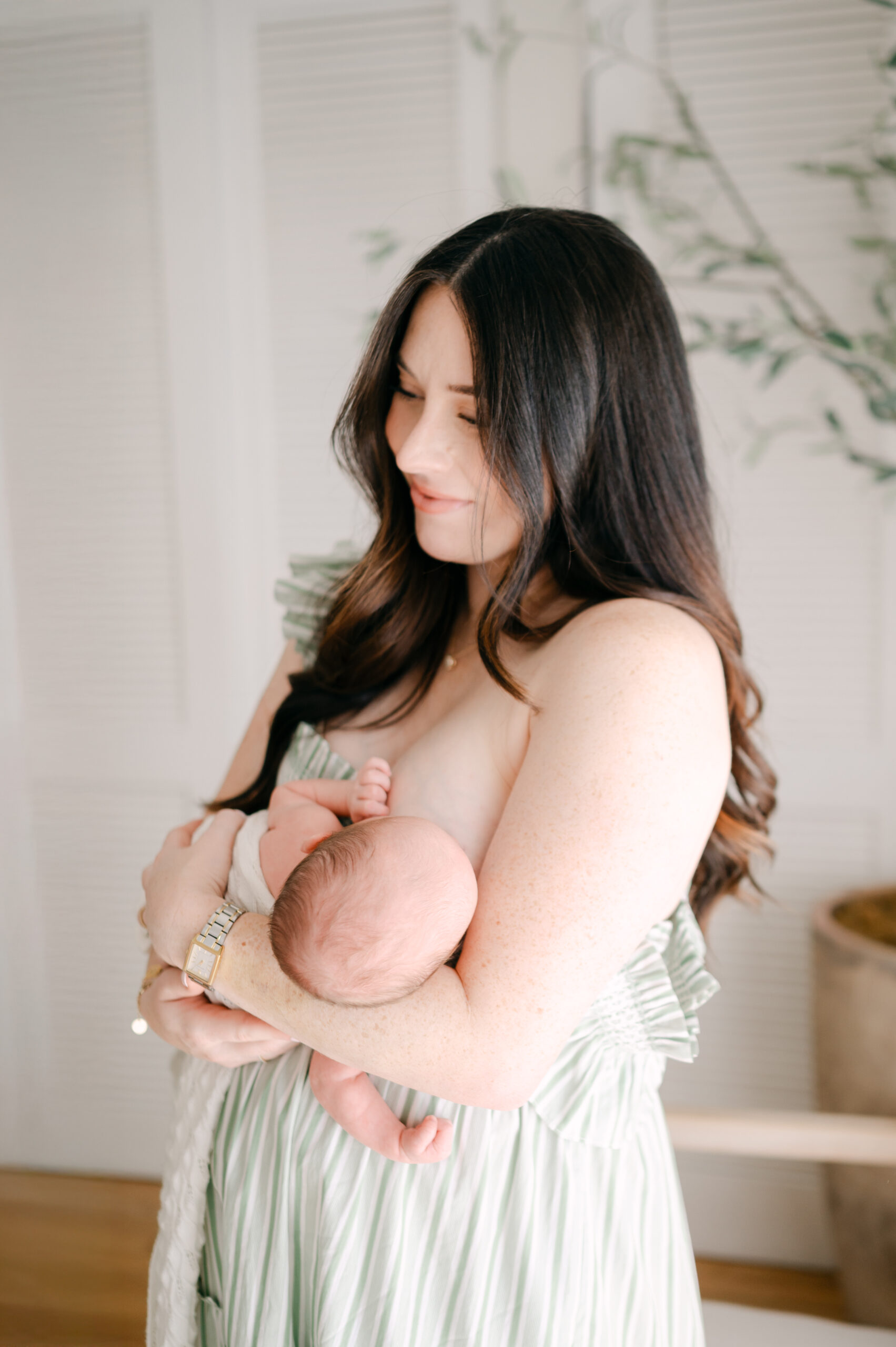 Mom nursing baby during Miami photoshoot