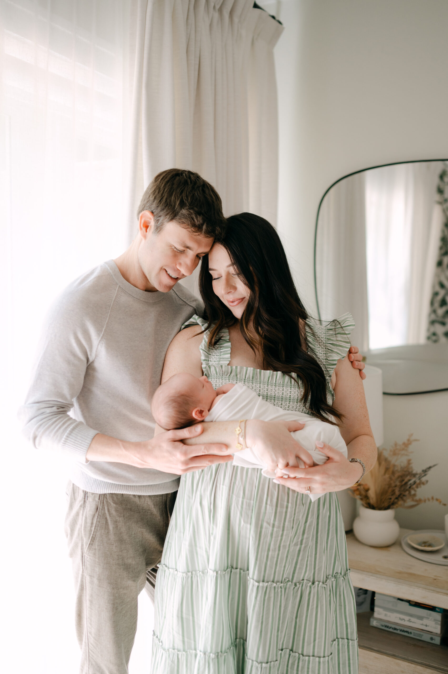 Dad and mom looking down at their newborn baby