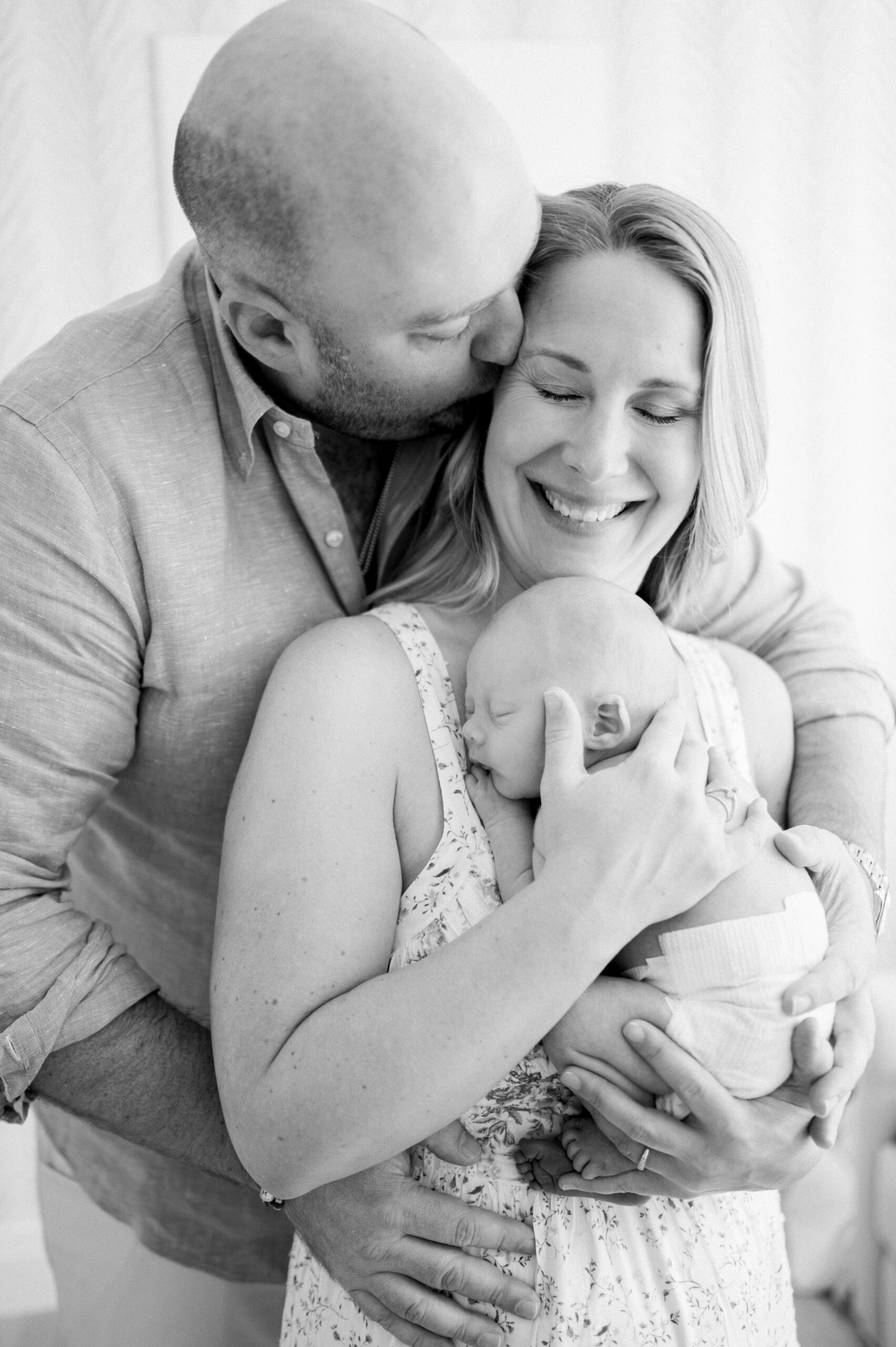 Parents holding their newborn baby at home Miami Beach lifestyle photographer 