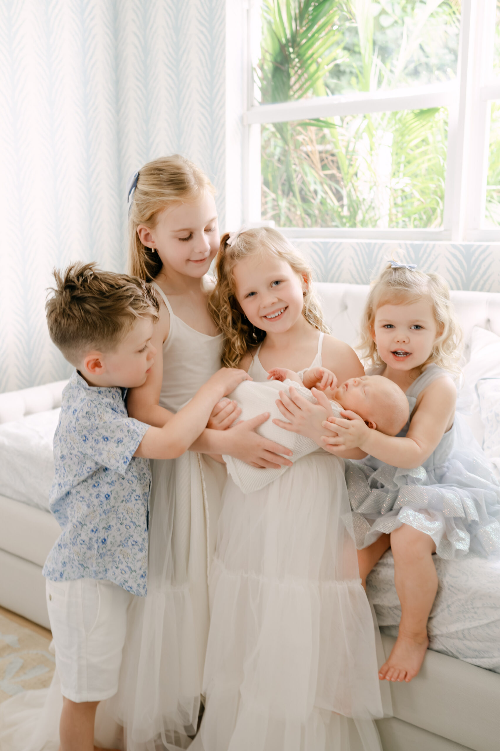 Newborn session with siblings Miami four kids meeting baby brother
